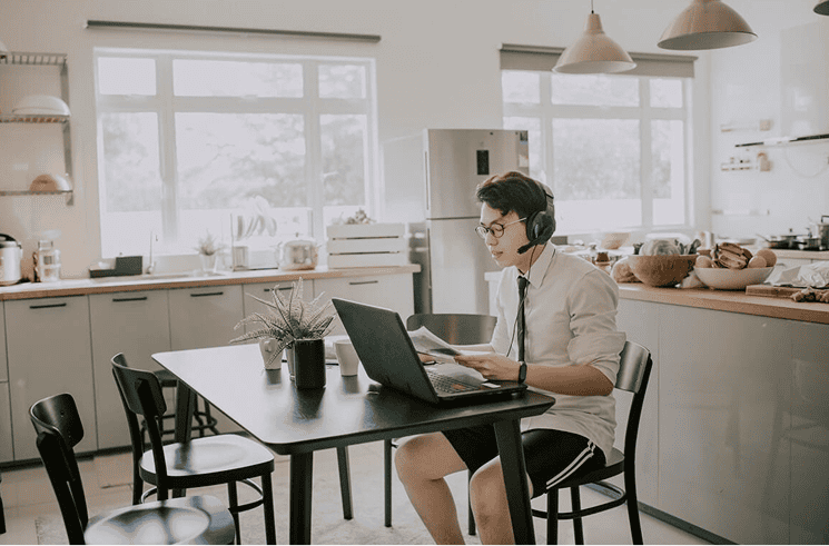 Remote worker using a laptop at a home desk